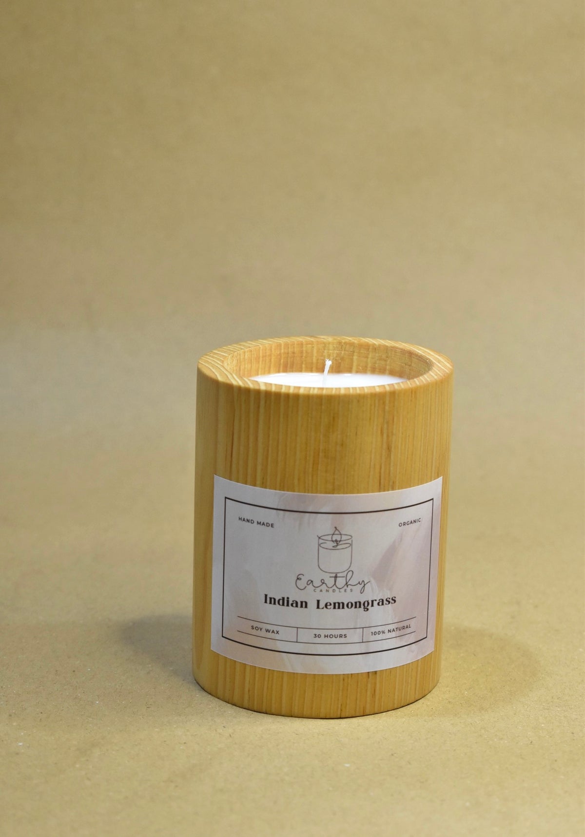 Indian Lemongrass candle in a cylindrical wooden vessel